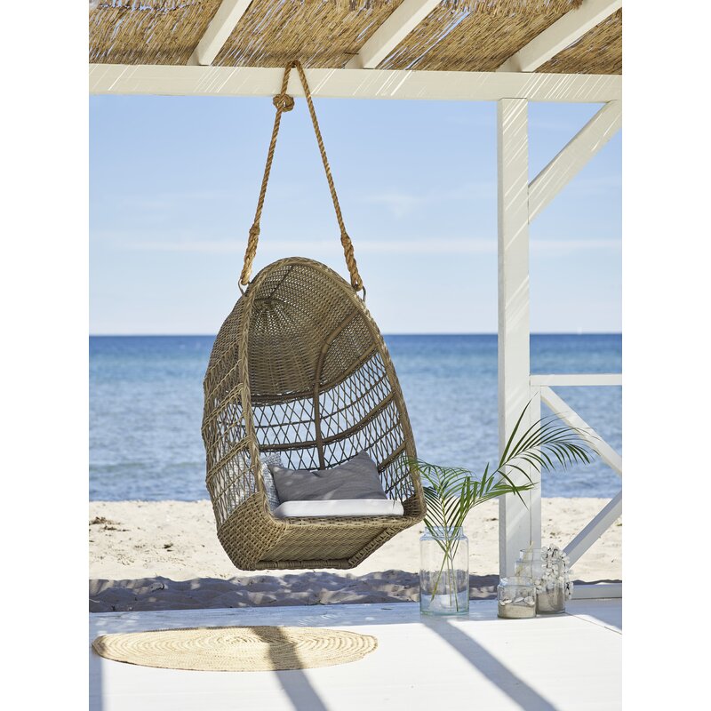 Evelyn-Outdoor-Swing-Basket-Chair-on-the-Beach-sika-design