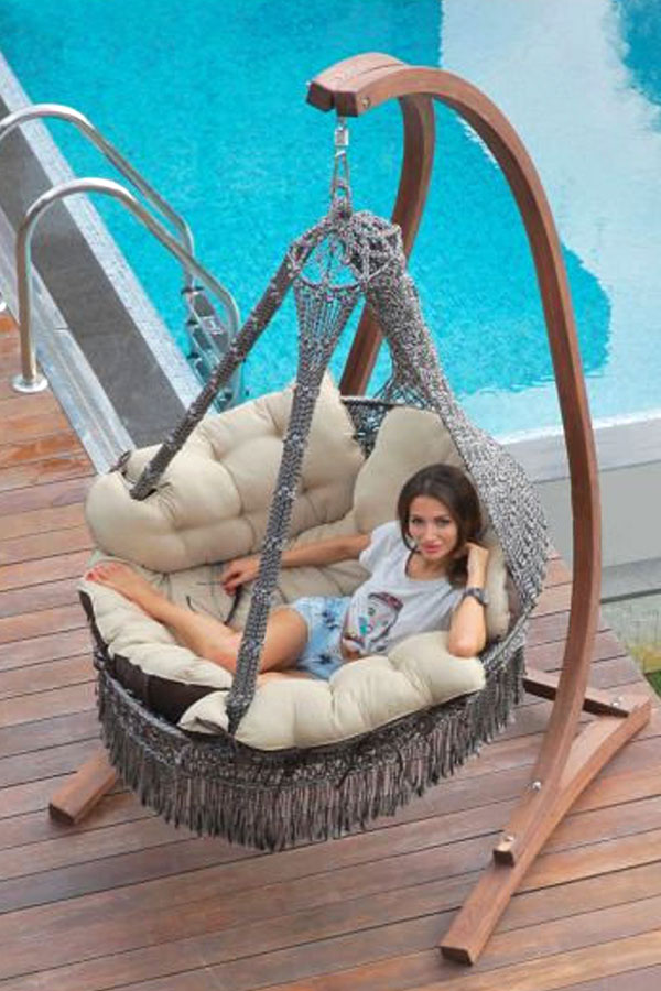 big-macrame-double-hanging-chair-with-thick-cushions-and-wooden-sturdy-stand-outdoors